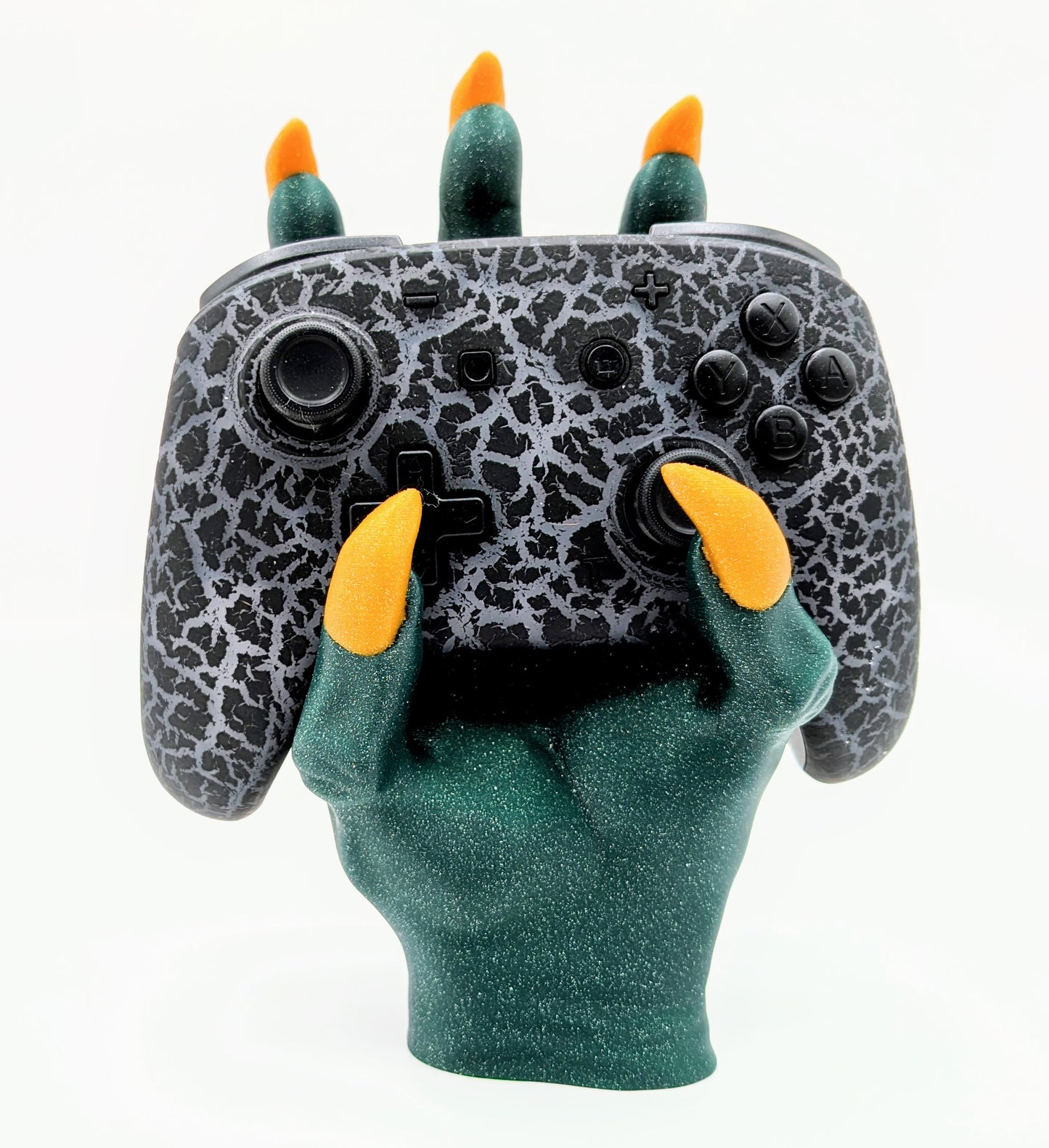 Monster Controller Stand holding a gaming controller with claws, featuring green glitter and orange claws for a spooky design.